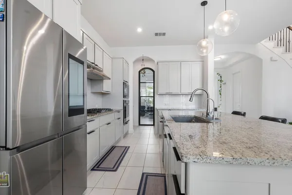 a kitchen with a stove oven and sink