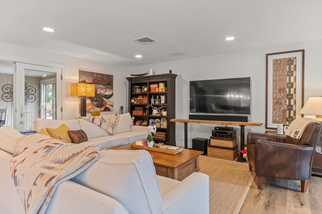 1 Captain Towne Road East Sandwich, MA 02537 - Photo 11 of 35 a bedroom with a bed a couch and a flat screen tv