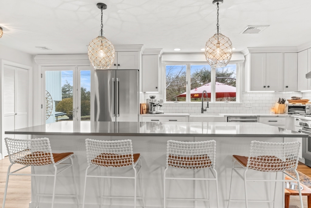1 Captain Towne Road East Sandwich, MA 02537 - Photo 4 of 35 a kitchen with stainless steel appliances granite countertop a sink and a chandelier