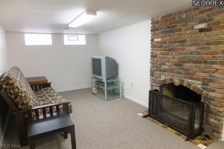 3533 Radcliffe Road Cleveland Heights, OH 44121 - Photo 11 of 12 The character and charm don't end upstairs! The brick fireplace in the finished lower level adds to the charm. Great space for a media room, playroom, office--anything you need!