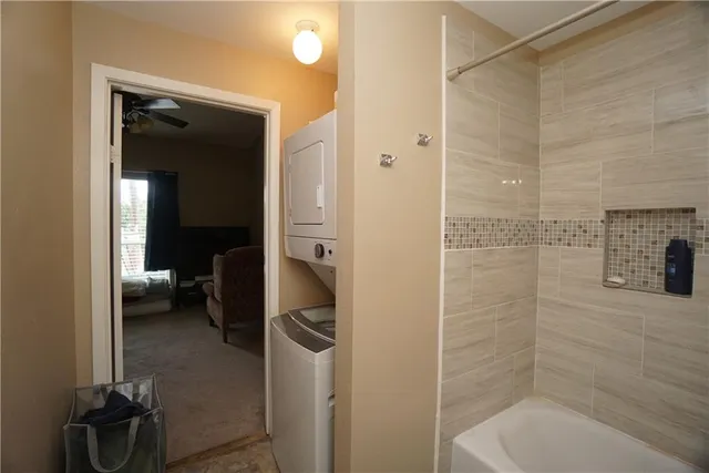 a bathroom with a tub and a toilet