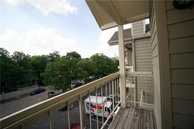 a balcony with wooden floor in front of it
