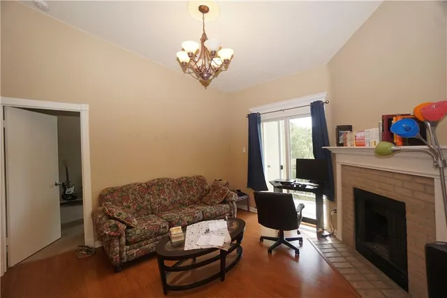 a living room with furniture fireplace and window