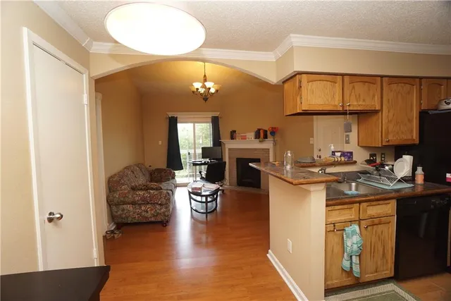 a kitchen with sink refrigerator and cabinets