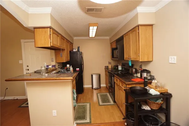 a kitchen with stainless steel appliances granite countertop a sink stove and cabinets