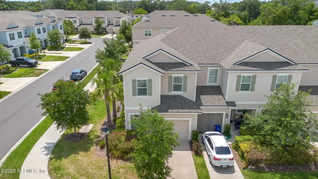 an aerial view of a house with a yard