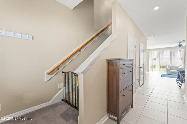 a view of hallway with stairs and furniture