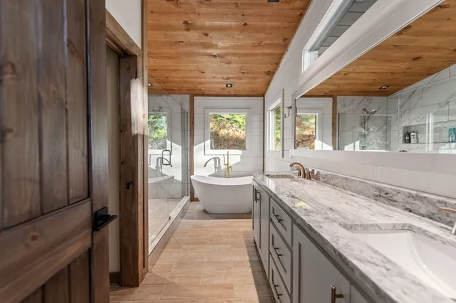a bedroom with furniture and large windows