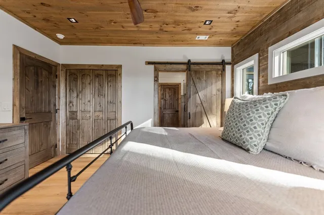 a view of a patio with table and chairs with wooden floor and fence