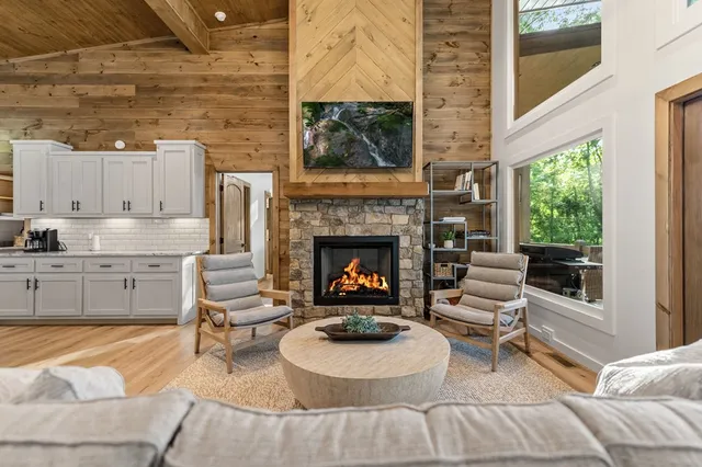 a living room with furniture a fireplace and a large window