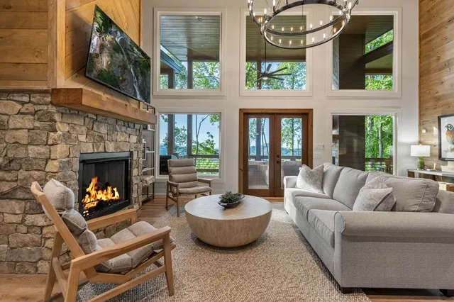 a living room with furniture a fireplace and a table