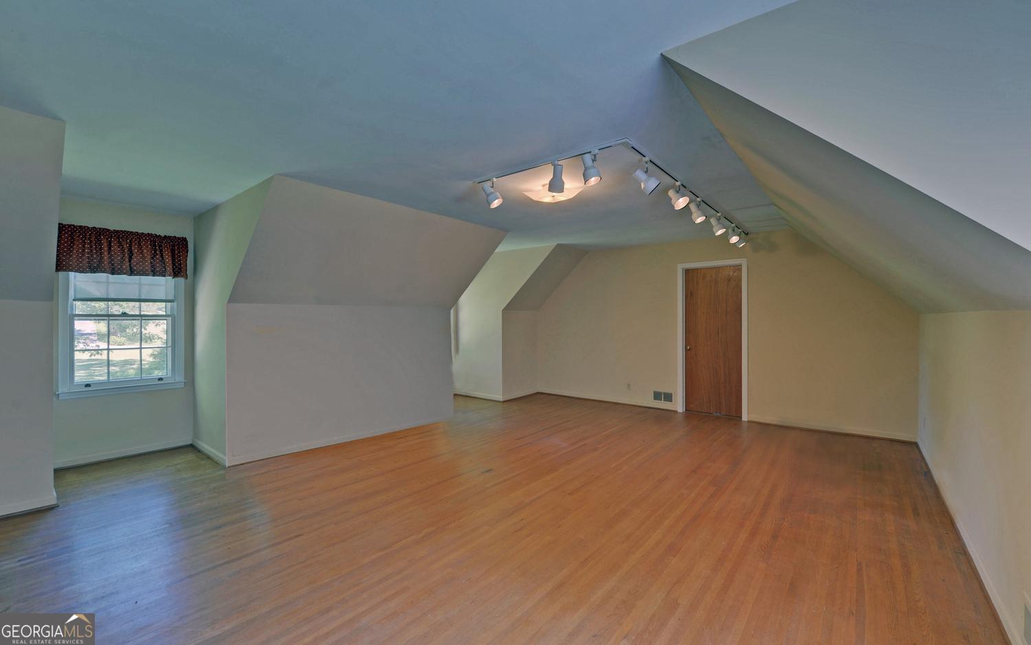400 Harris Street Toccoa, GA 30577 - Photo 29 of 49 an empty room with wooden floor and windows