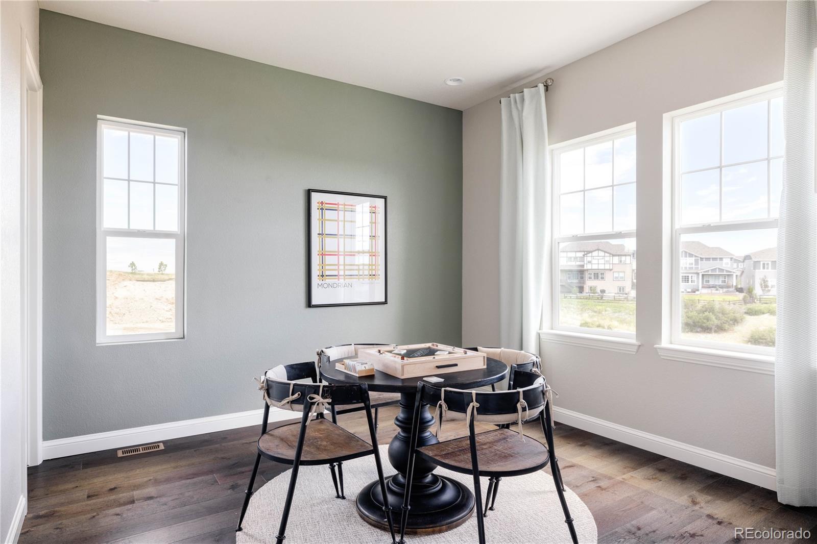 3966 Breakcamp Court Castle Rock, CO 80108 - Photo 16 of 46 a dining room with wooden floor and a window