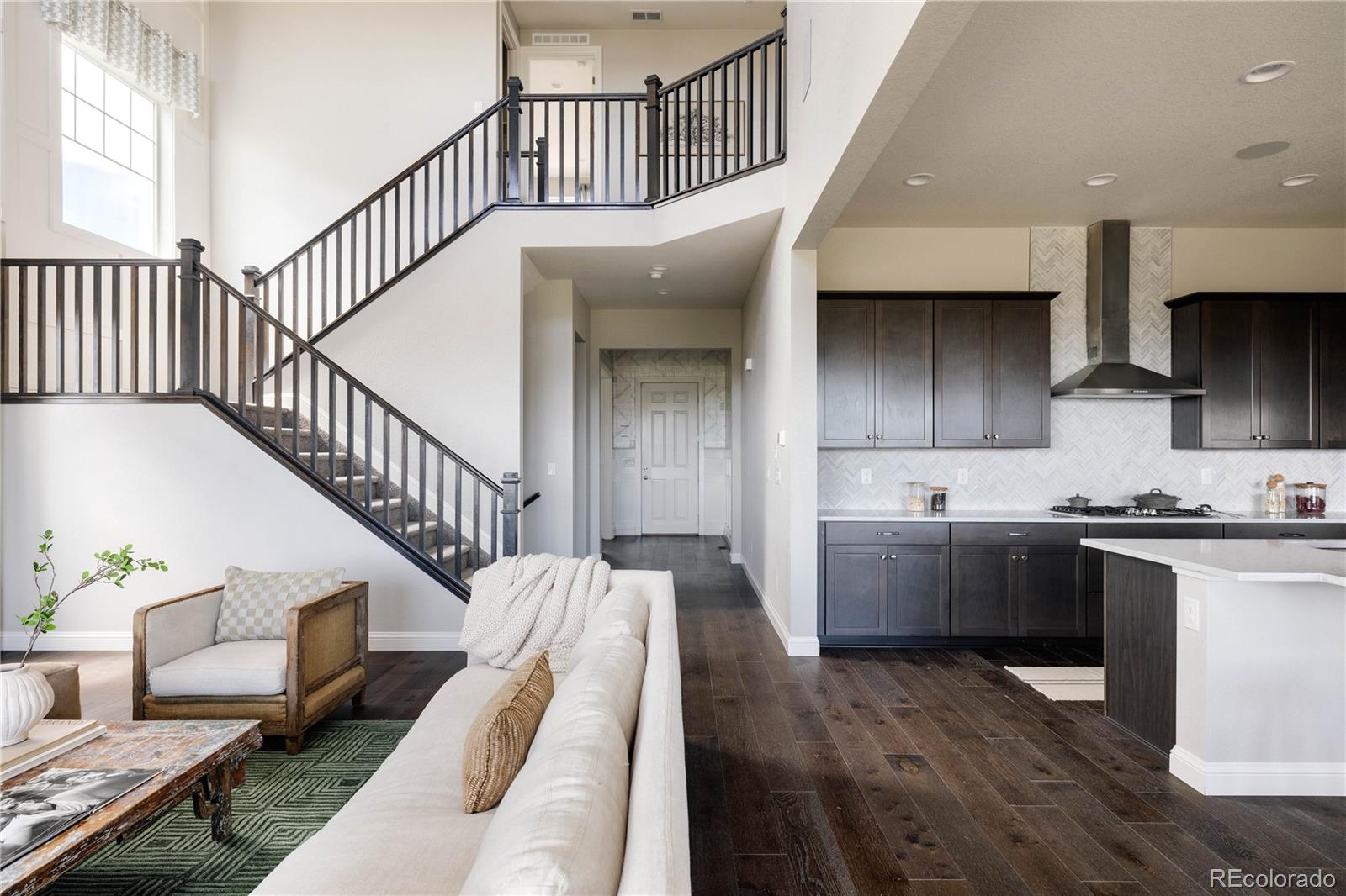 3966 Breakcamp Court Castle Rock, CO 80108 - Photo 20 of 46 a view of entryway and kitchen with wooden floor