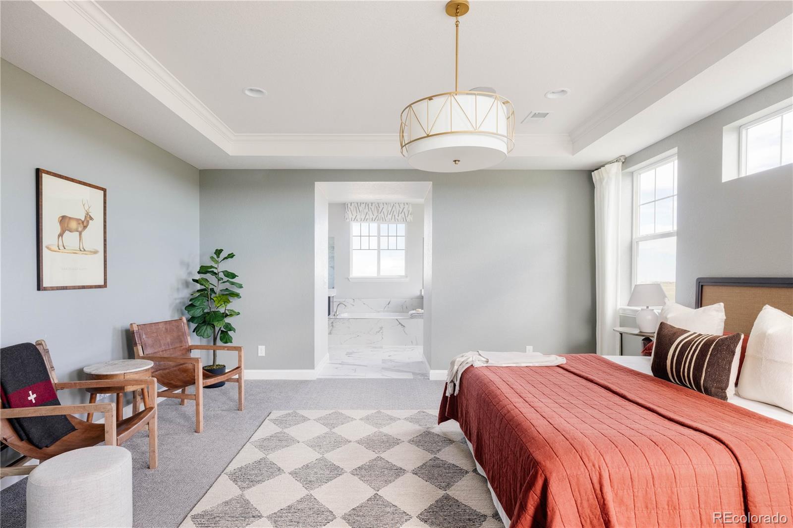 3966 Breakcamp Court Castle Rock, CO 80108 - Photo 22 of 46 a bedroom with a large bed and a chandelier