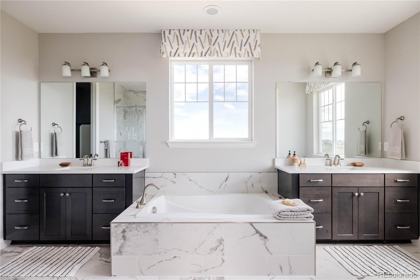 3966 Breakcamp Court Castle Rock, CO 80108 - Photo 24 of 46 a spacious bathroom with a tub sink and mirror