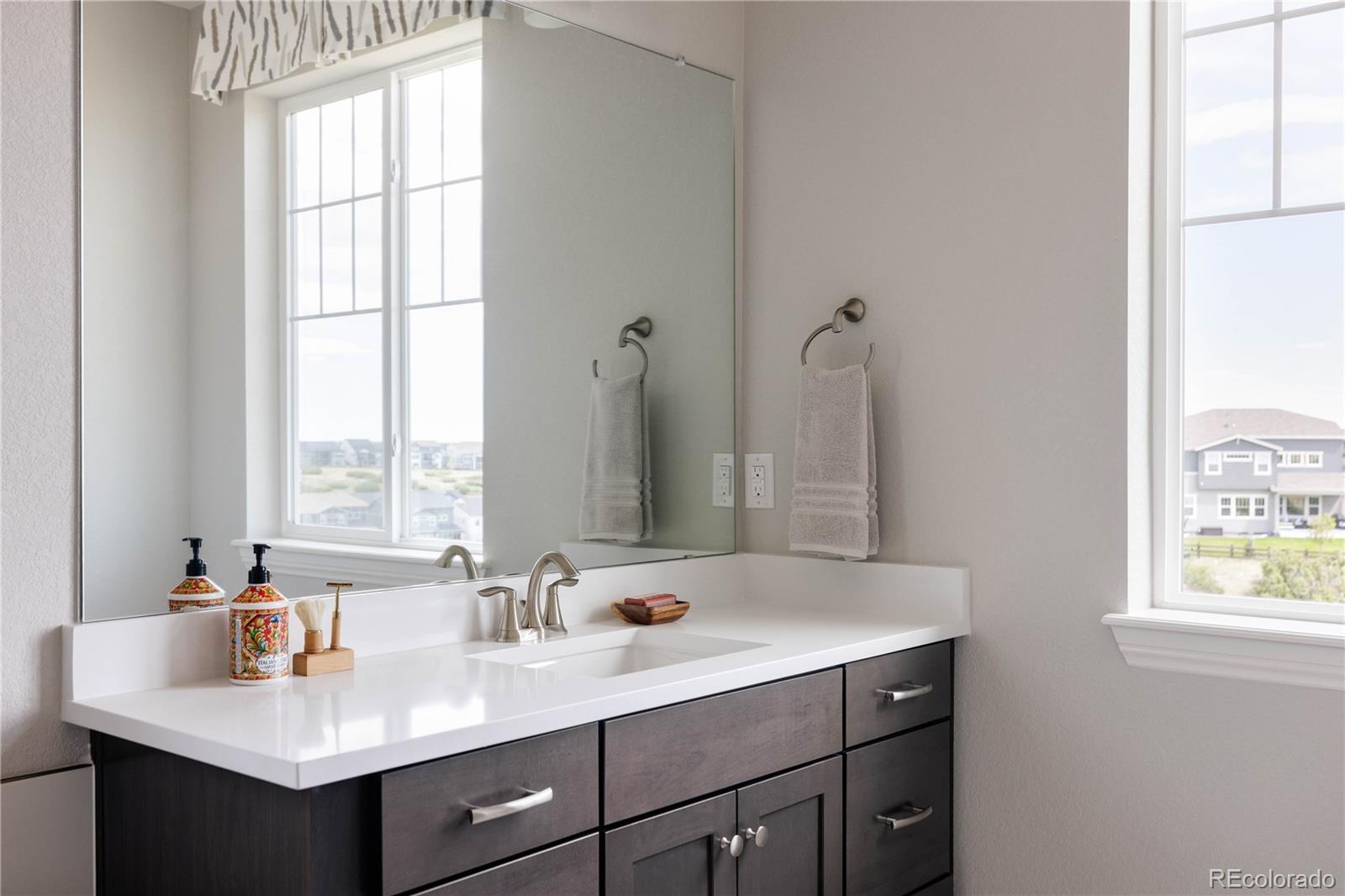 3966 Breakcamp Court Castle Rock, CO 80108 - Photo 25 of 46 a bathroom with a sink vanity and a mirror