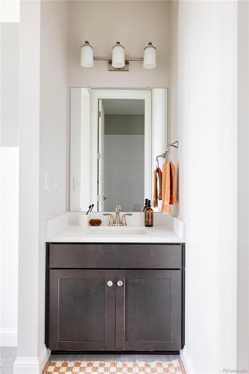 3966 Breakcamp Court Castle Rock, CO 80108 - Photo 31 of 46 a bathroom with a sink vanity and a mirror