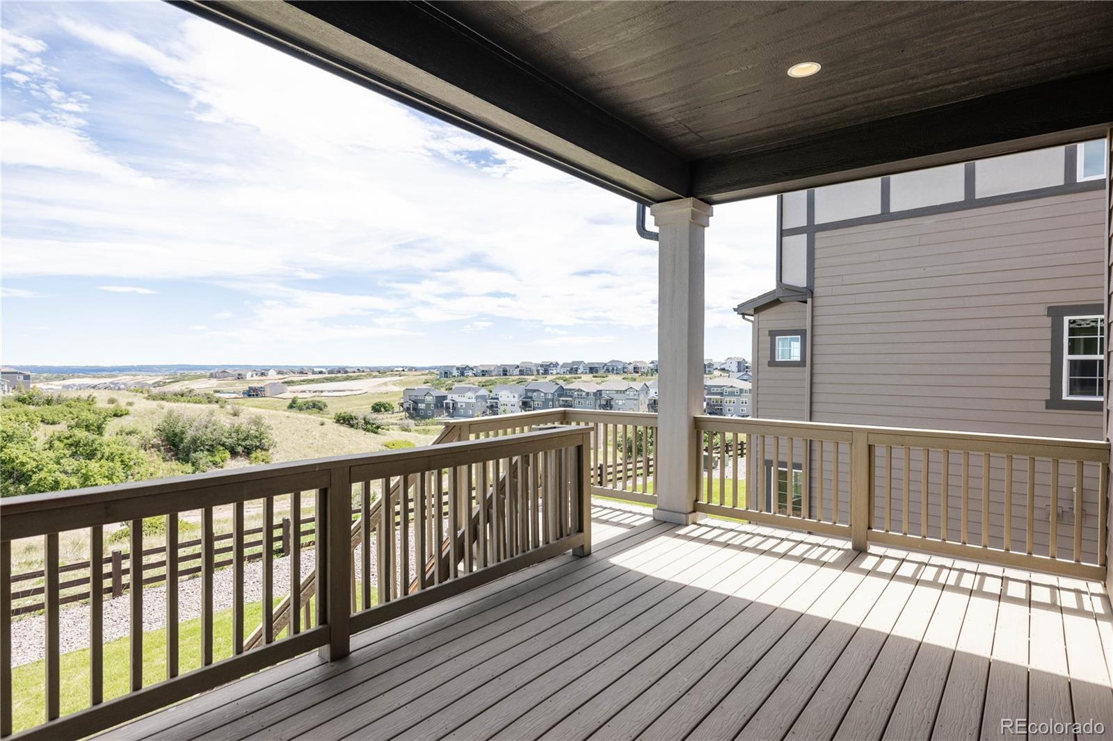 3966 Breakcamp Court Castle Rock, CO 80108 - Photo 41 of 46 a view of a balcony with wooden floor next to a yard
