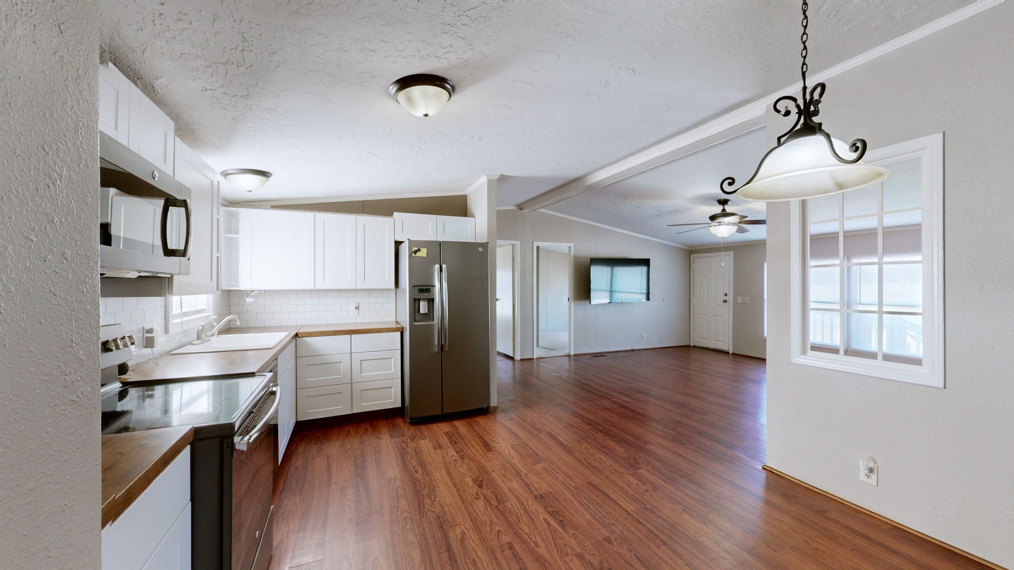 574 Benson Road Manchester, TN 37355 - Photo 12 of 41 a kitchen with stainless steel appliances granite countertop a refrigerator a sink dishwasher a stove and white countertops with wooden floor