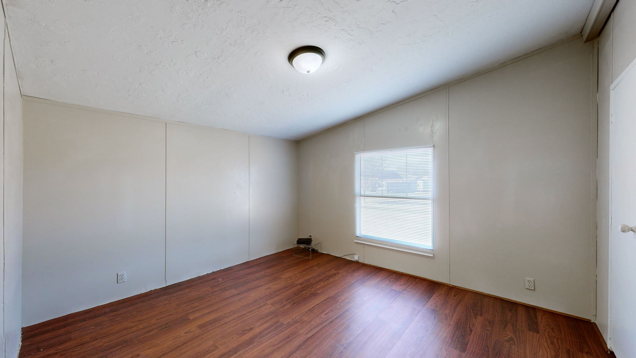 574 Benson Road Manchester, TN 37355 - Photo 21 of 41 an empty room with wooden floor and windows