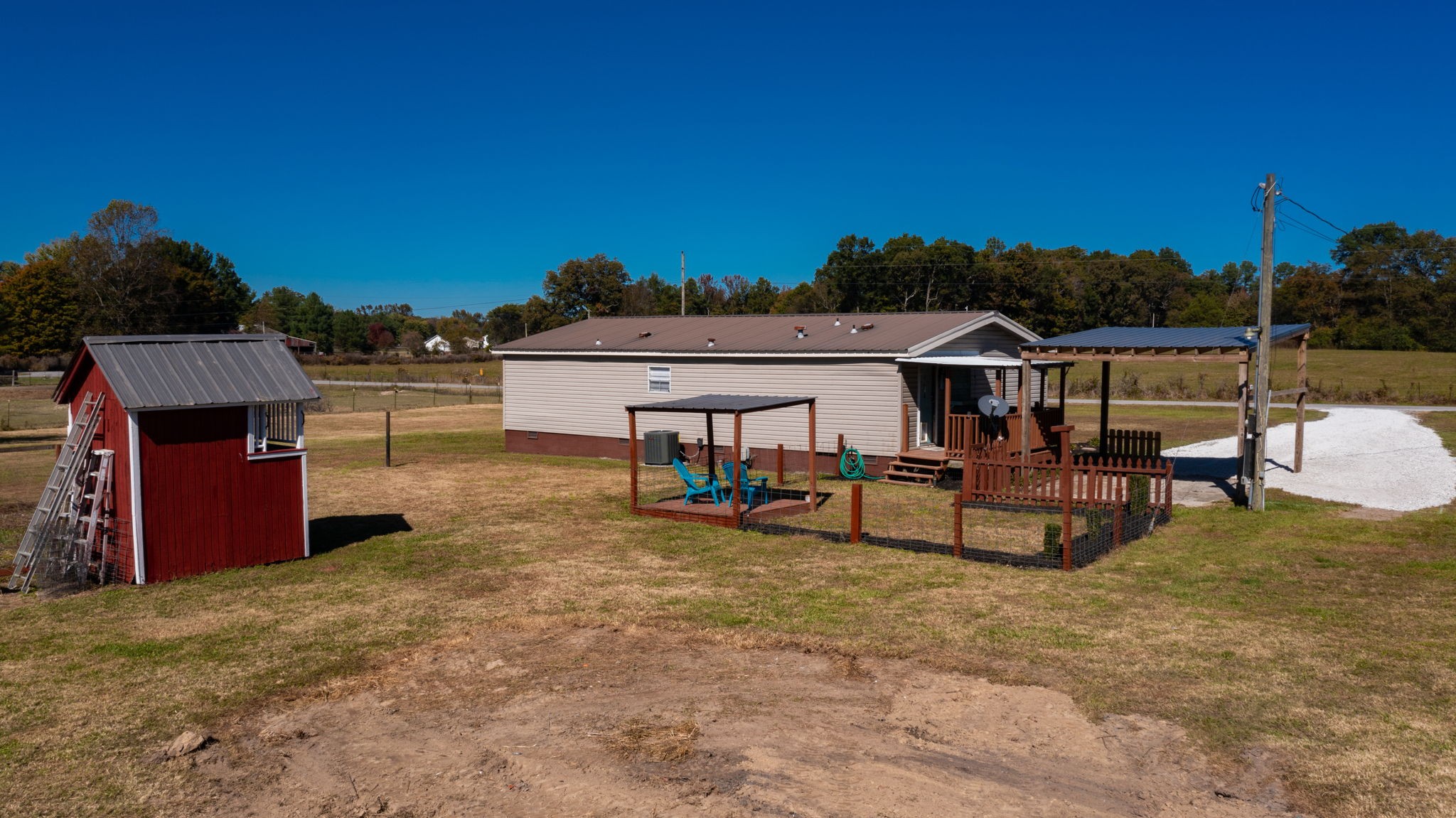 574 Benson Road Manchester, TN 37355 - Photo 35 of 41 a view of a swimming pool with a bench and some trees
