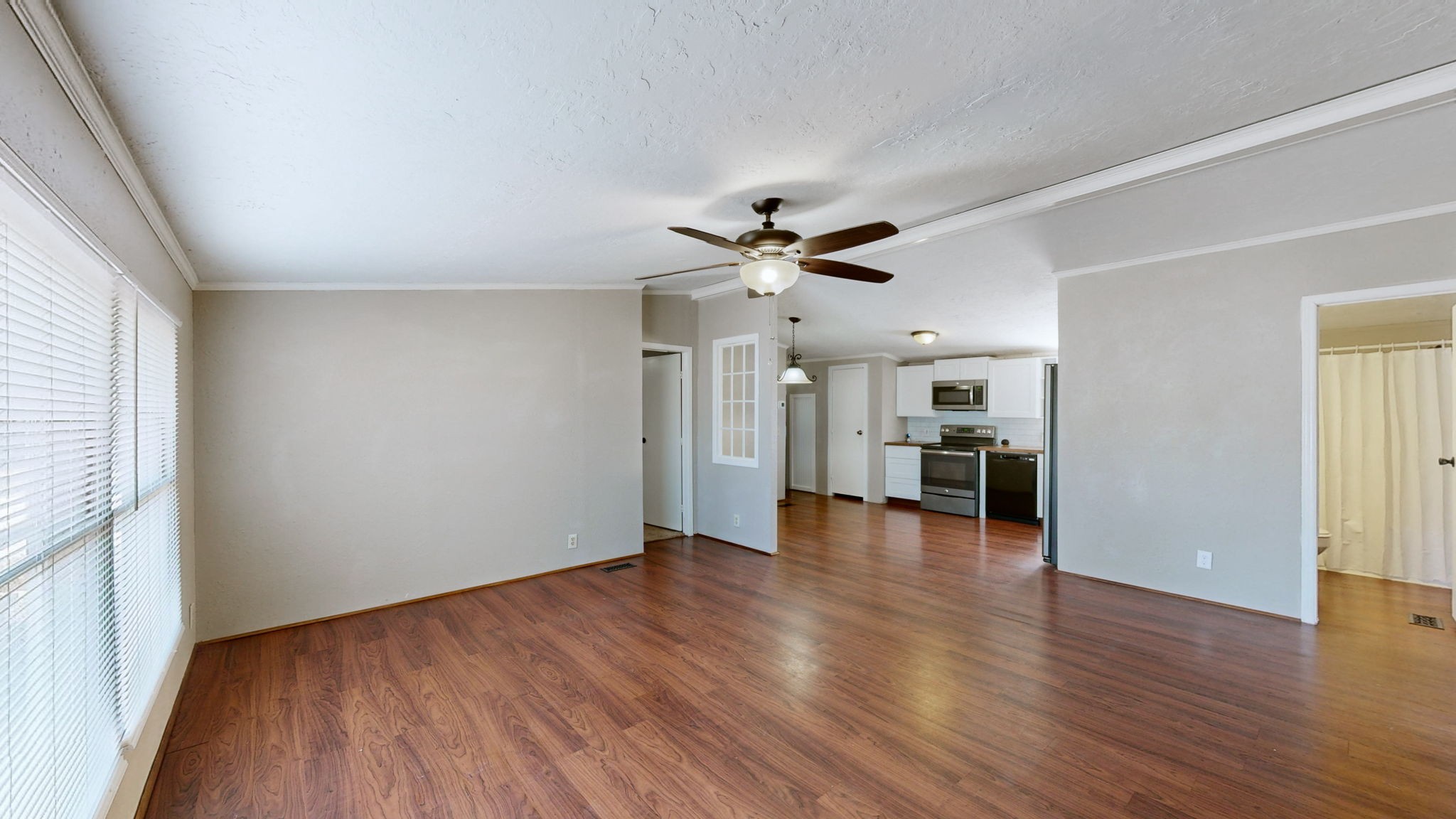 574 Benson Road Manchester, TN 37355 - Photo 7 of 41 a view of empty room with wooden floor and ceiling fan