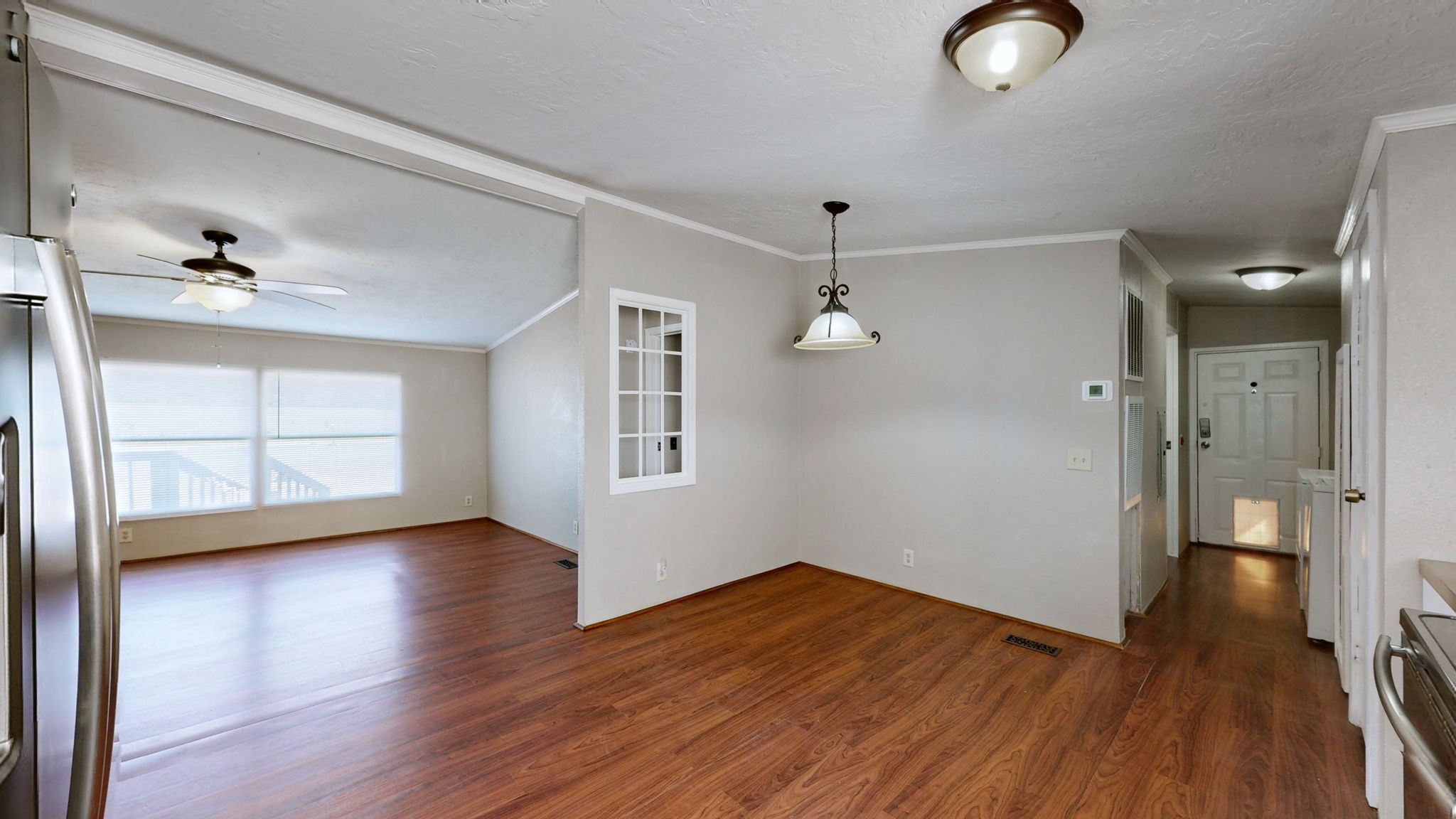 574 Benson Road Manchester, TN 37355 - Photo 8 of 41 a view of an empty room with wooden floor and a window