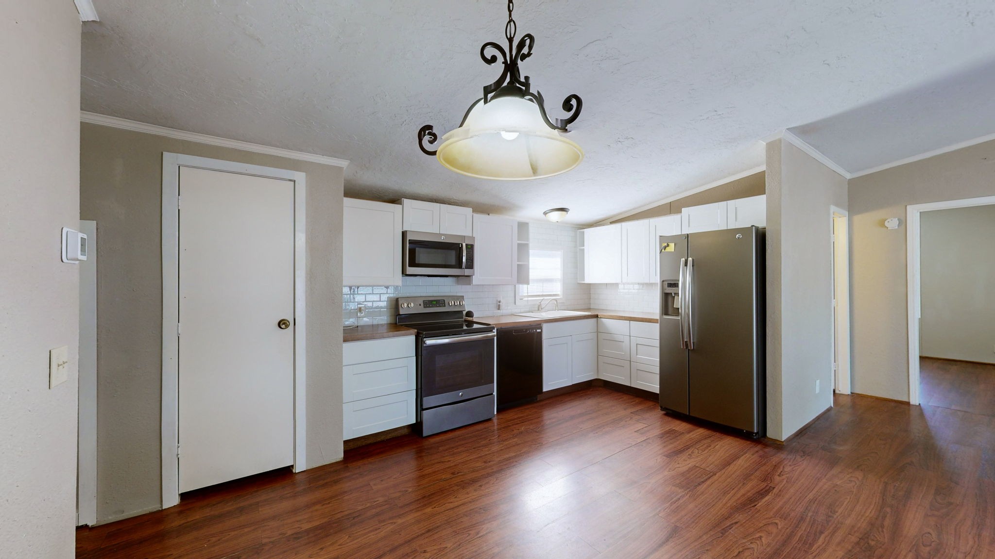 574 Benson Road Manchester, TN 37355 - Photo 9 of 41 a kitchen with stainless steel appliances granite countertop a refrigerator a stove a sink and a wooden floors