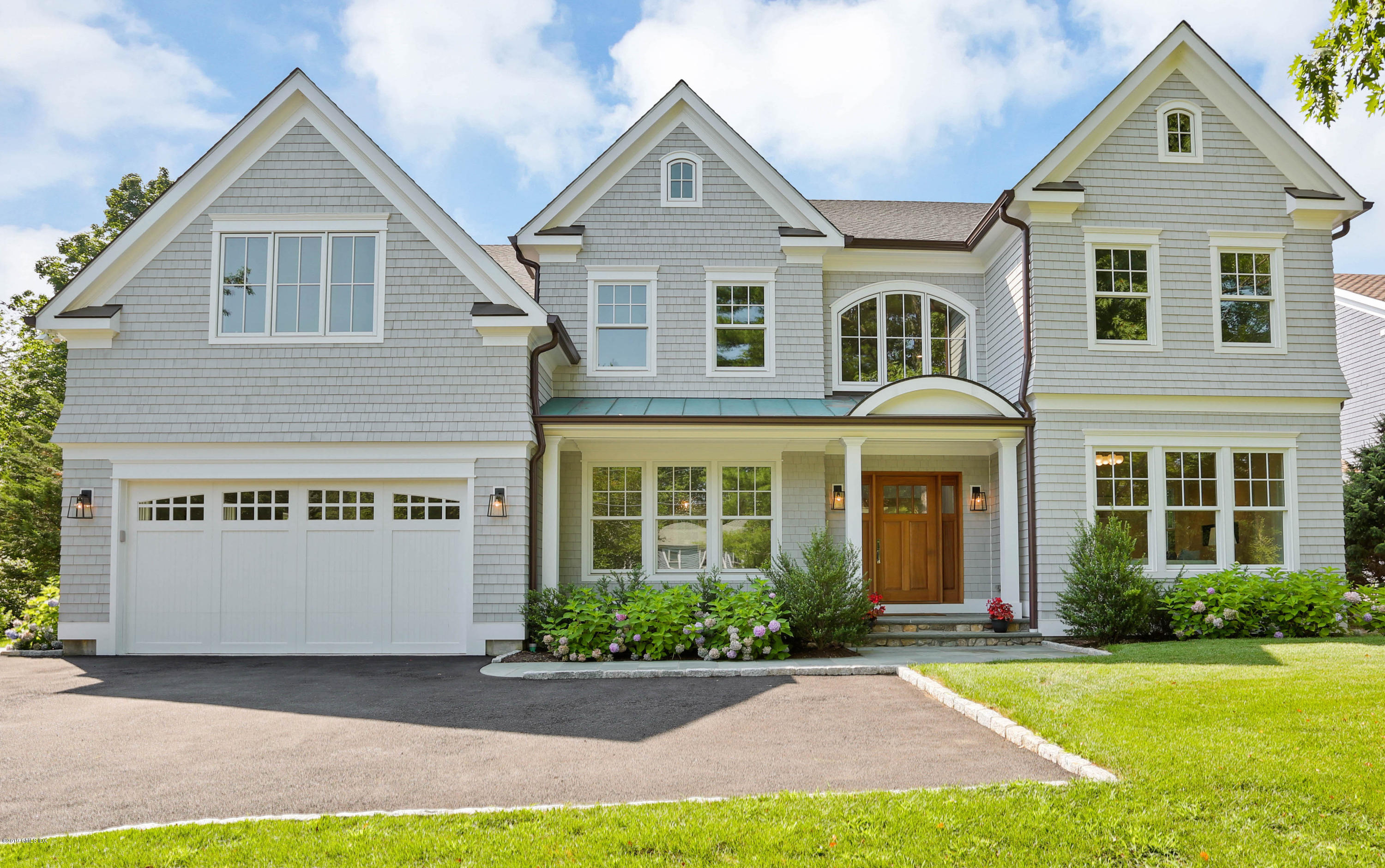62 Lockwood Road Riverside, CT 06878 - Photo 1 of 18 a front view of a house with a yard and garage