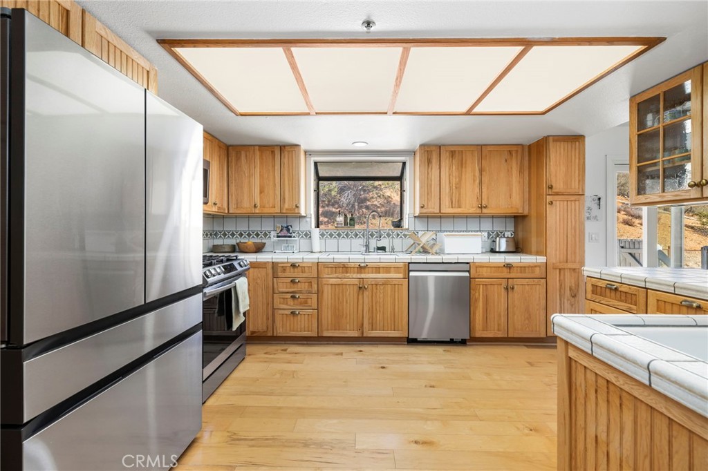 35607 Red Rover Mine Road Acton, CA 93510 - Photo 12 of 42 a kitchen with a sink stainless steel appliances cabinets and a large window