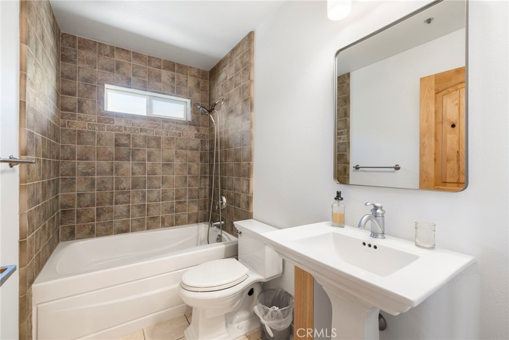 35607 Red Rover Mine Road Acton, CA 93510 - Photo 23 of 42 a bathroom with a bathtub a sink a toilet and mirror