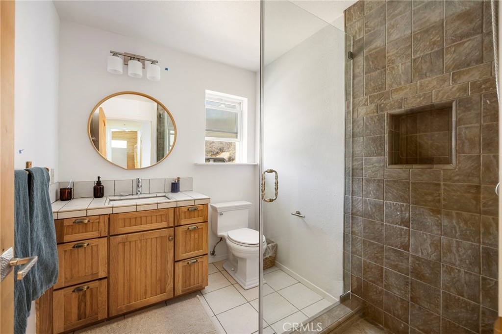 35607 Red Rover Mine Road Acton, CA 93510 - Photo 26 of 42 a bathroom with a toilet sink vanity and mirror