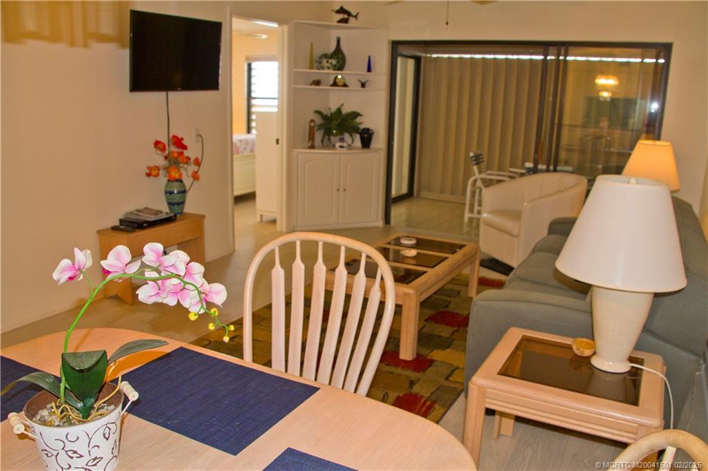 4620 Northeast Sandpebble Trace, Unit 405 Stuart, FL 34996 - Photo 13 of 26 a view of a room that has a couch and a potted plant