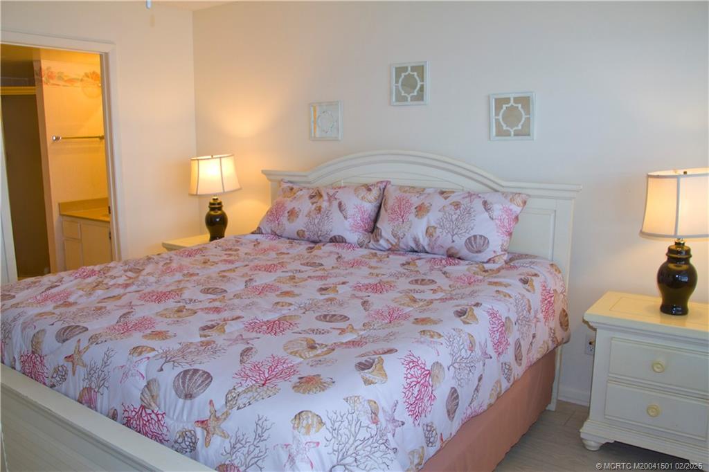 4620 Northeast Sandpebble Trace, Unit 405 Stuart, FL 34996 - Photo 17 of 26 a bedroom with a bed and a dresser in it