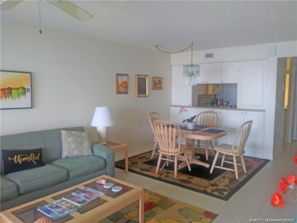 4620 Northeast Sandpebble Trace, Unit 405 Stuart, FL 34996 - Photo 8 of 26 a dining room with furniture and a wooden floor