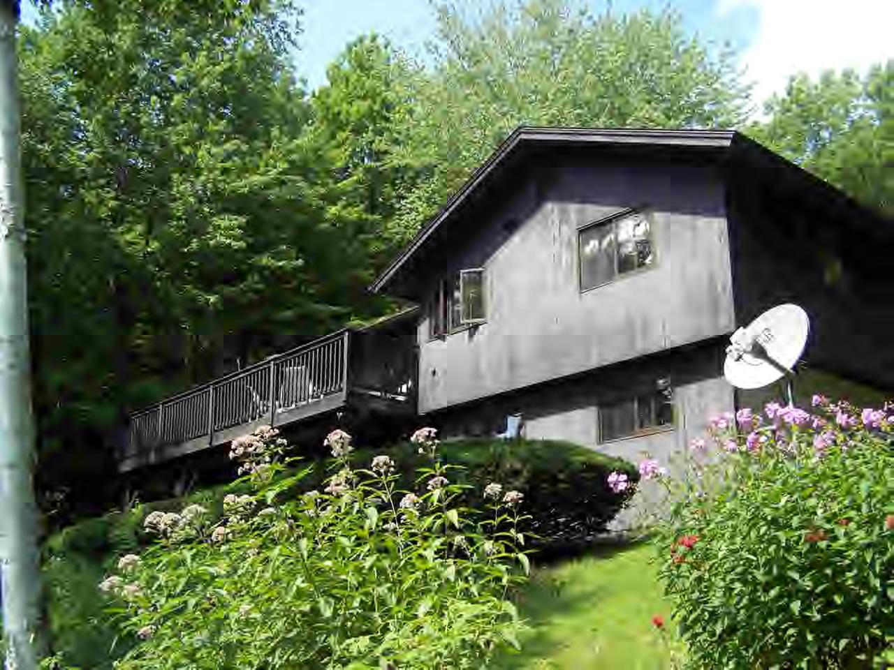 a view of a house with a flower garden