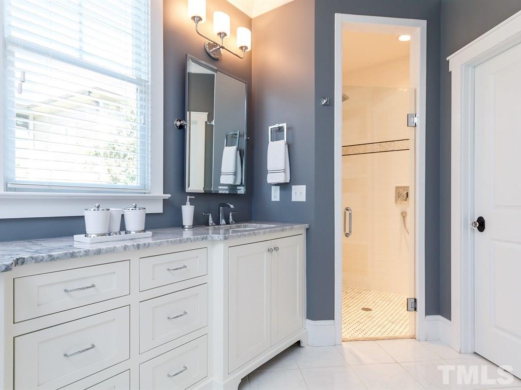 5015 Langley Circle Raleigh, NC 27609 - Photo 14 of 25 a bathroom with a granite countertop sink and a mirror