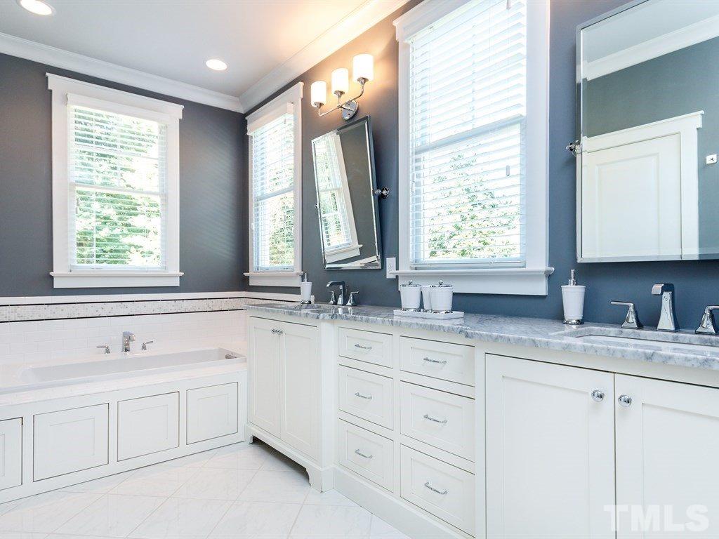 5015 Langley Circle Raleigh, NC 27609 - Photo 16 of 25 a bathroom with double sink window and mirror