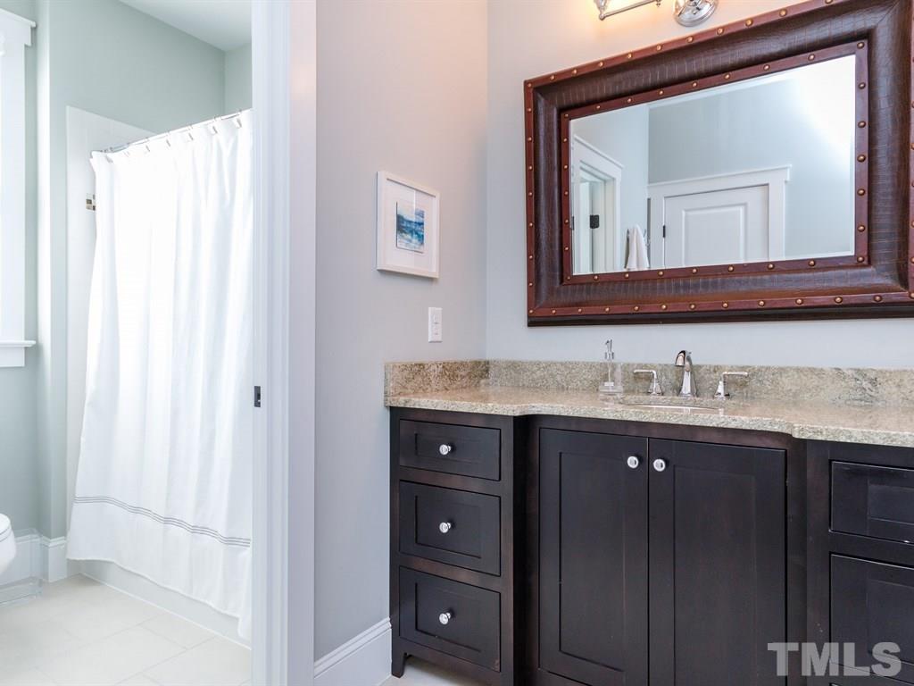 5015 Langley Circle Raleigh, NC 27609 - Photo 19 of 25 a bathroom with a granite countertop sink vanity and mirror