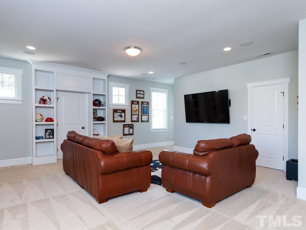 5015 Langley Circle Raleigh, NC 27609 - Photo 20 of 25 a living room with furniture and a flat screen tv