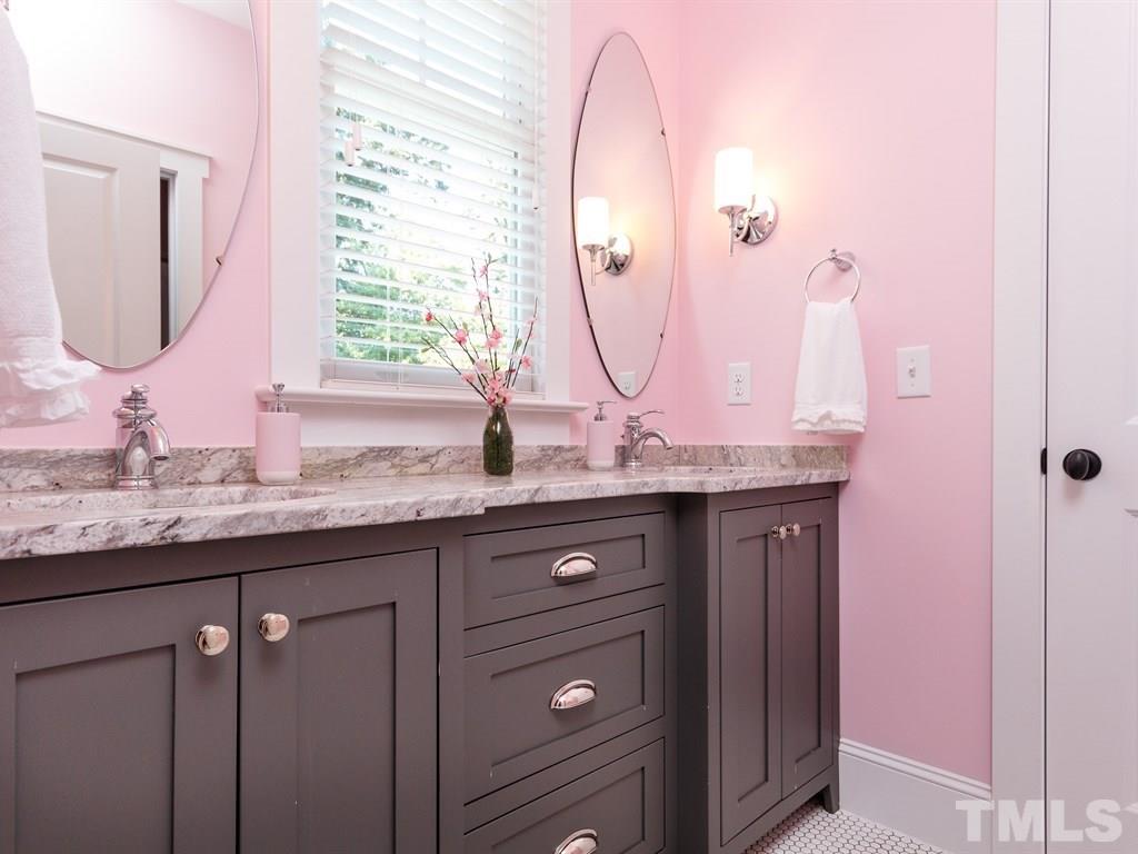 5015 Langley Circle Raleigh, NC 27609 - Photo 22 of 25 a bathroom with a granite countertop sink and a mirror