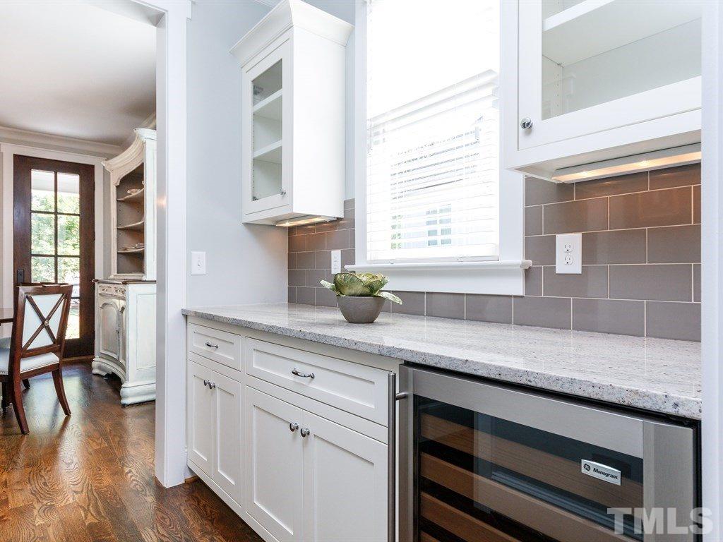 5015 Langley Circle Raleigh, NC 27609 - Photo 7 of 25 a kitchen with stainless steel appliances cabinets and a wooden floor
