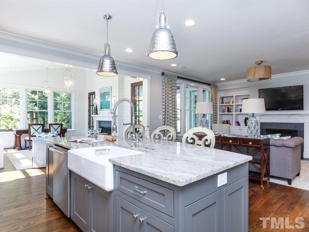 5015 Langley Circle Raleigh, NC 27609 - Photo 8 of 25 a kitchen with granite countertop a sink a counter top space appliances and cabinets