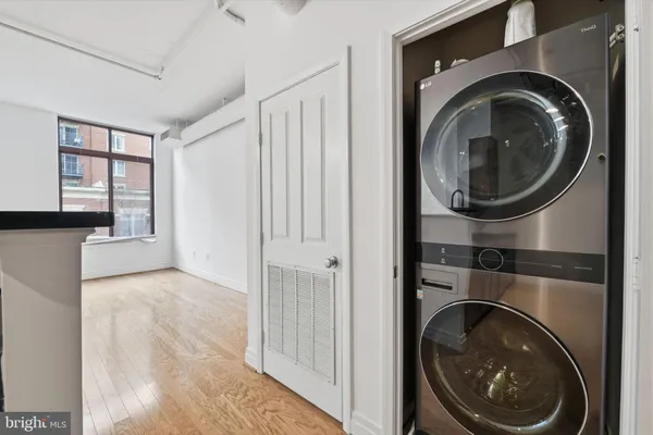 a view of a hallway with washer and dryer