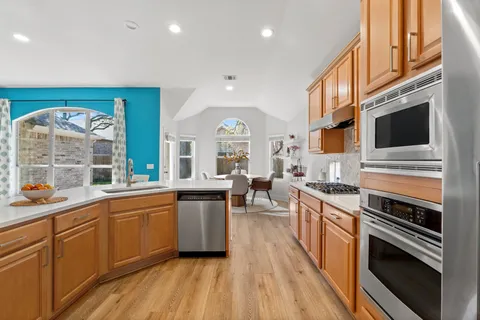 a kitchen with lots of counter top space and wooden floor
