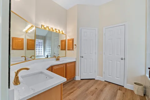 a bathroom with a granite countertop sink a shower and a mirror