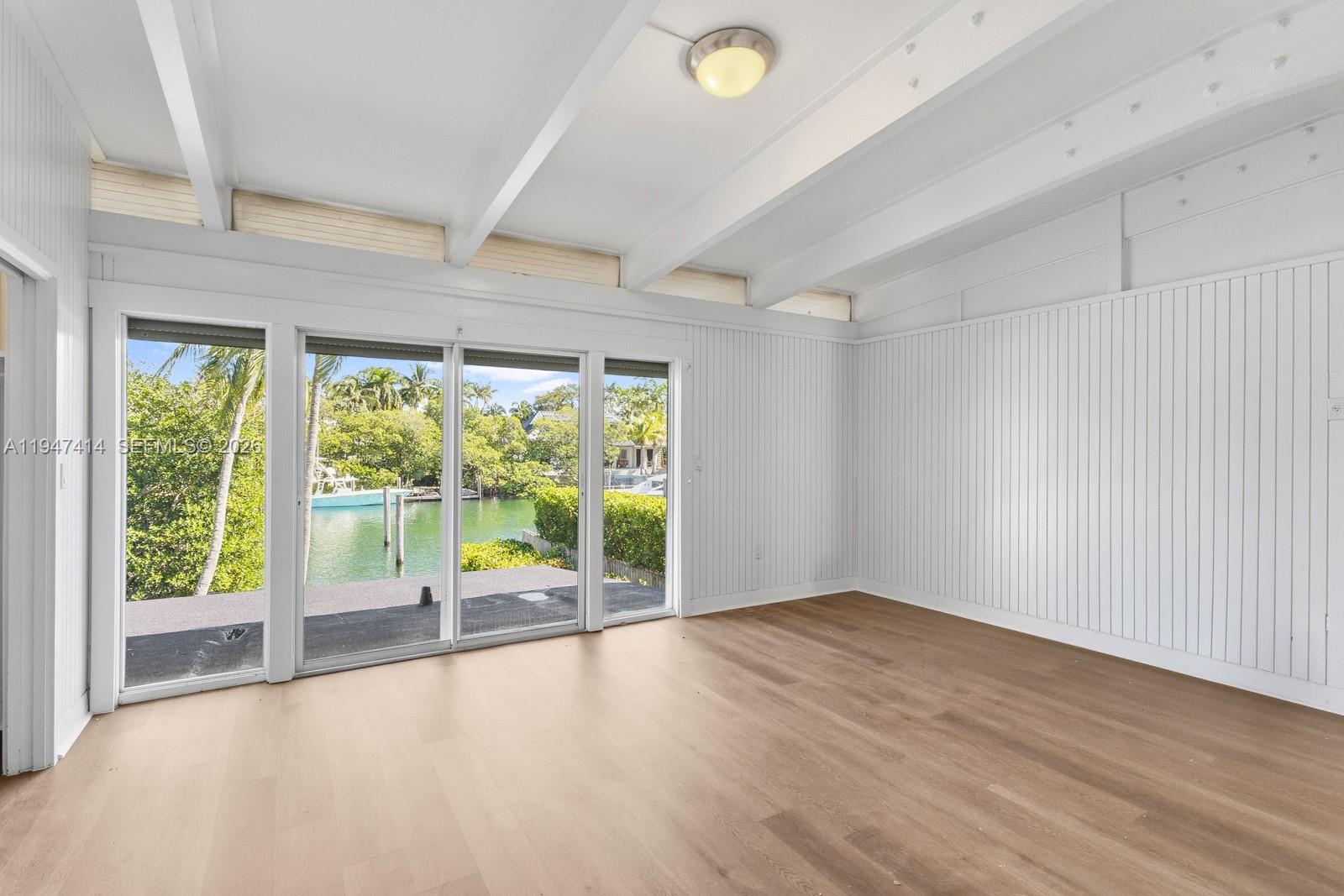 4 Harbor Point Key Biscayne, FL 33149 - Photo 17 of 29 an empty room with wooden floor and windows