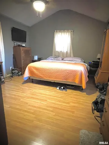 a room with a bed and a mirror on the dresser