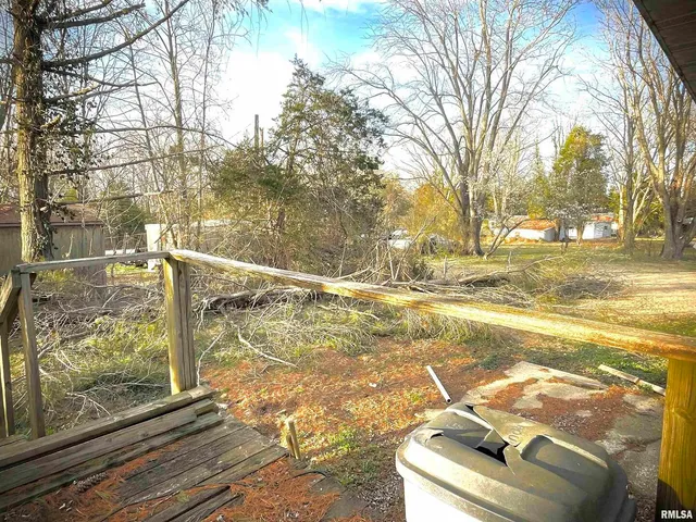 a view of a house with a small backyard